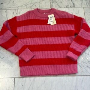 On 34th pink and redd sweater.made with recycled polyester. X-small
